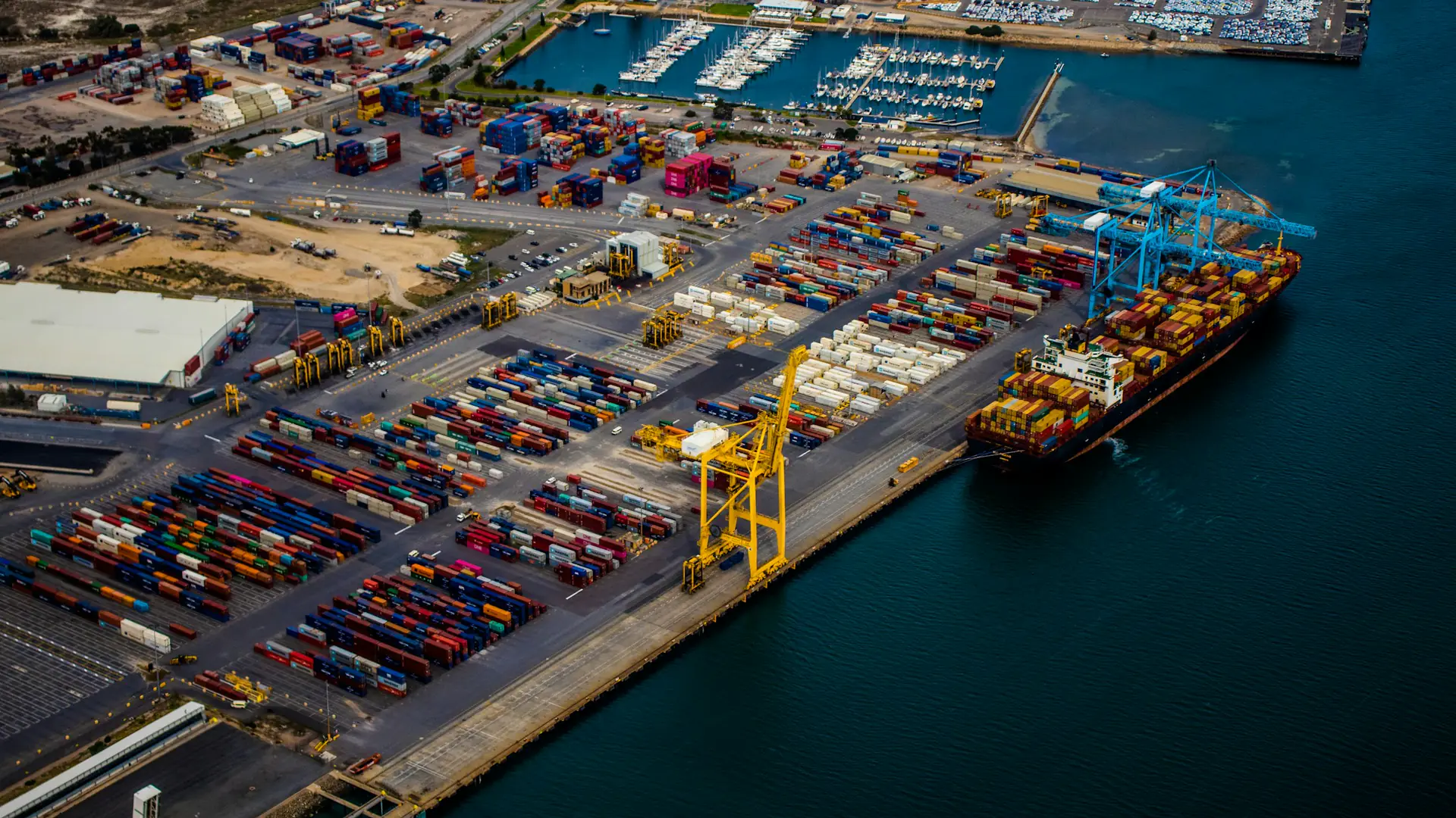 Aerial view of a container port with a ship at the quay
